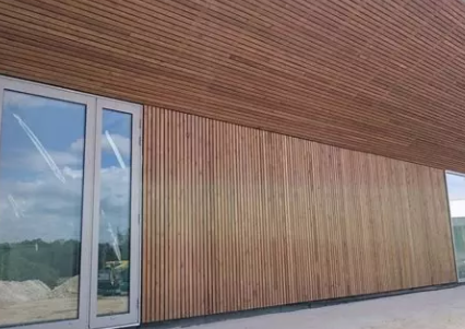 Installation of wooden cladding on commercial façade